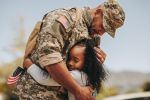 soldier hugging his daughter goodbye - visitation during deployment concept
