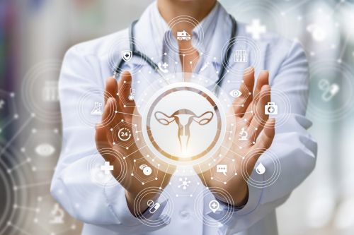 Fertility doctor shows icon of female uterus. Fertility, surrogacy, and assisted reproductive technology concept.
