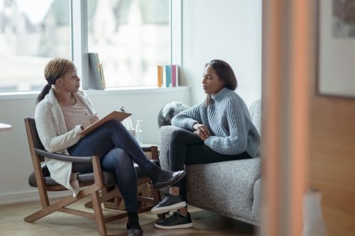 A Therapist meets with her female client in her office - psychological screening for surrogacy concept