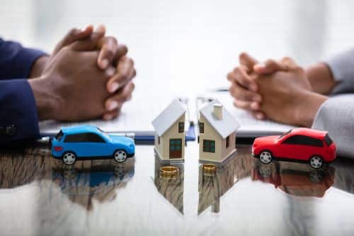 Wife And Husband Splitting House And Car During Divorce Process - who gets the house in a divorce concept