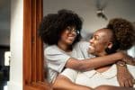 Adult child over 18 happy and hugging her adoptive mother - adult adoption concept
