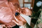 Close-up of a army soldier holding a wedding ring - service members civil relief act and divorce concept