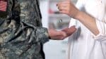 Wife giving necklace ring back to US male soldier